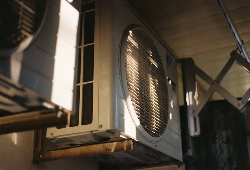 An outdoor air conditioning condenser in bright daylight