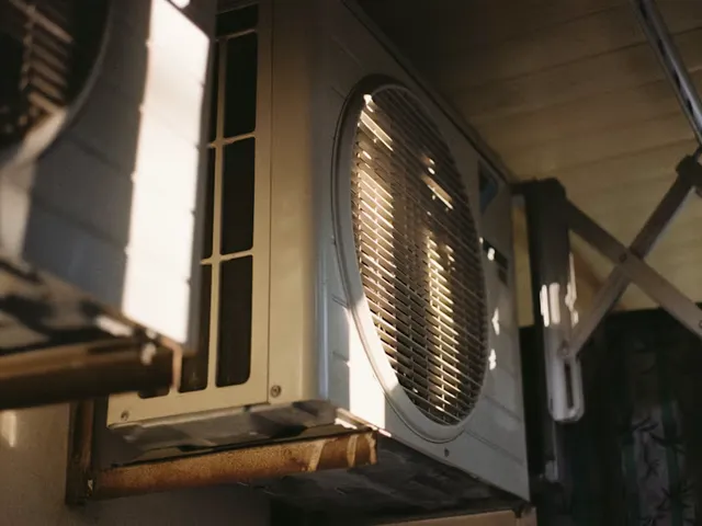 An outdoor air conditioning condenser in bright daylight