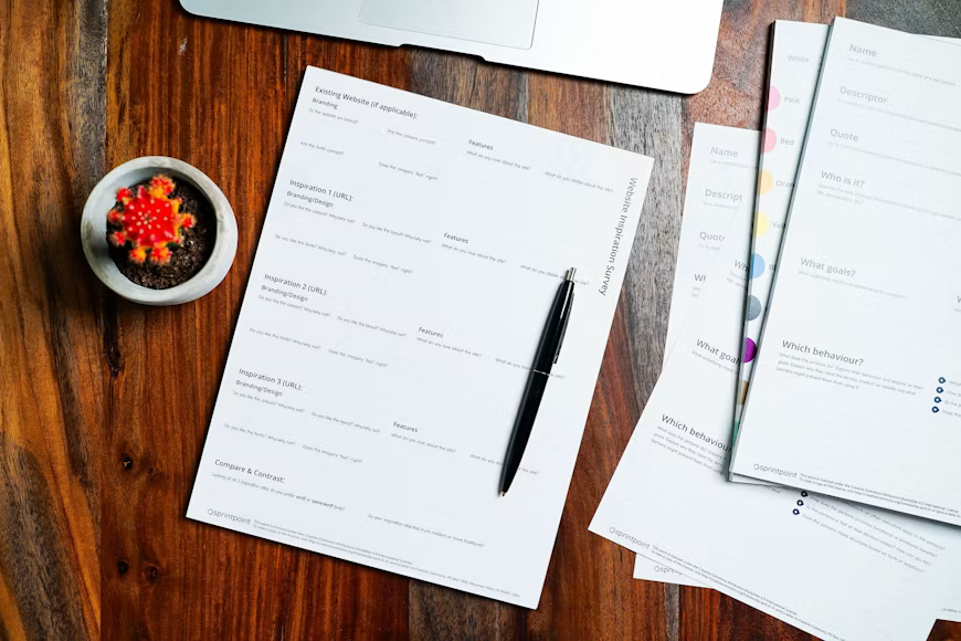 Policy documents and a pen on a wooden table