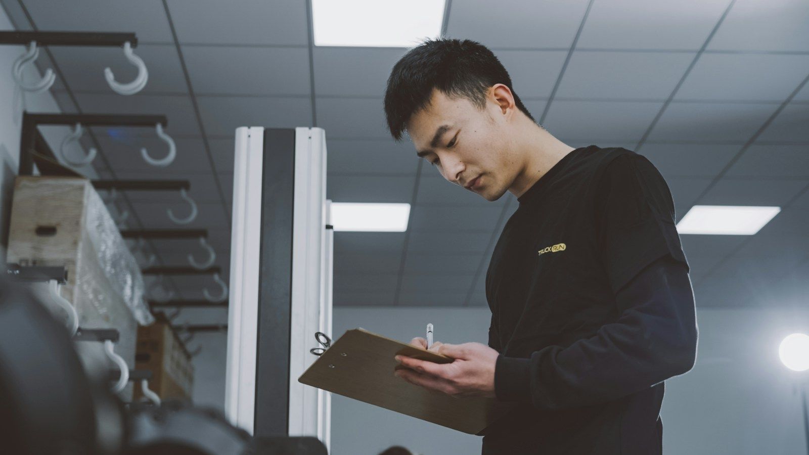 Man looking at a clipboard inside a building